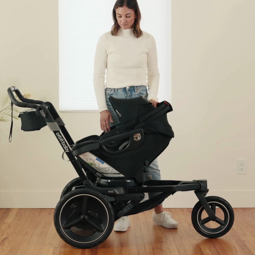 Orbit Baby Infant Car Seat docked on the X5 Jogging Stroller SmartHub
